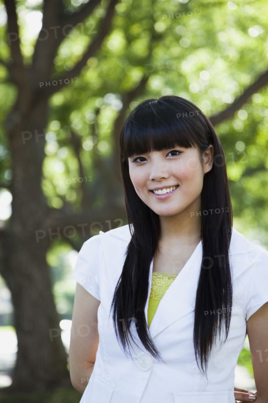 Asian woman smiling in park
