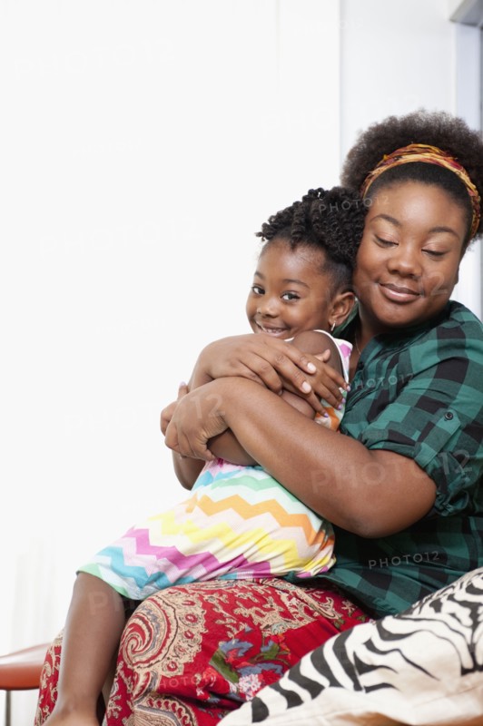 African American mother holding daughter on lap