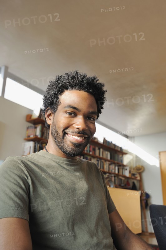 Black man smiling in living room
