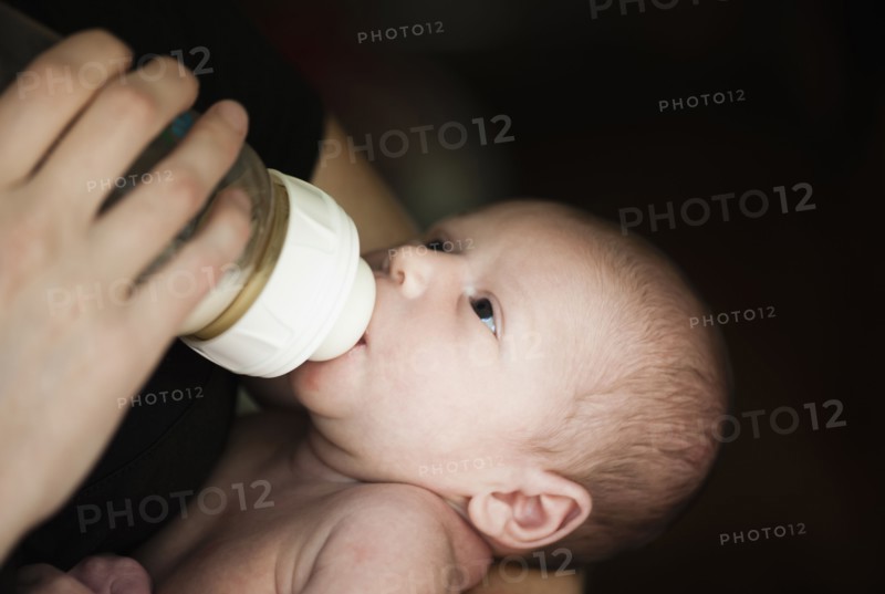 Close up of mother feeding newborn baby