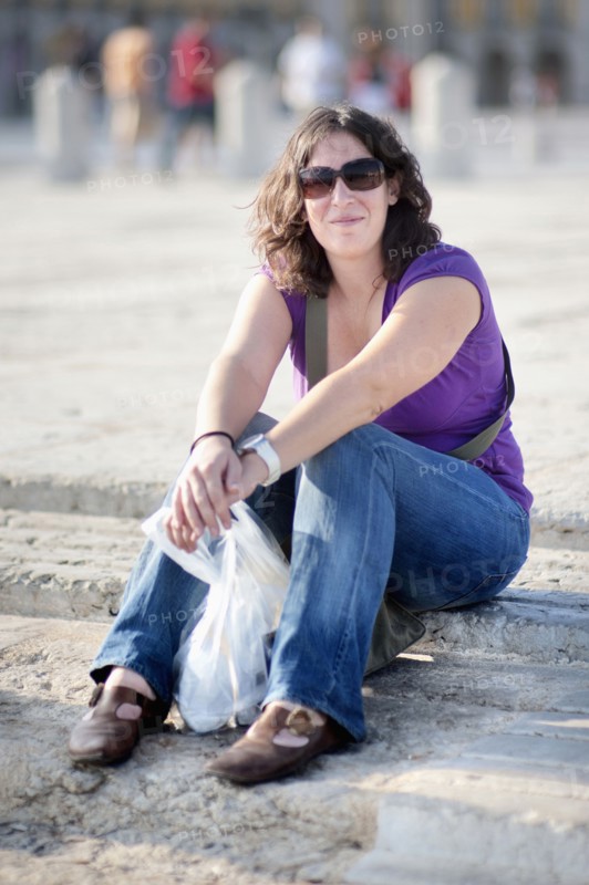 Caucasian woman sitting on steps