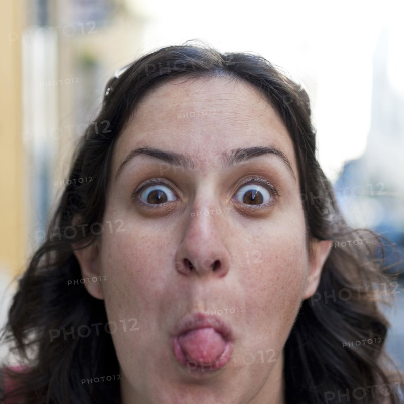 Caucasian woman sticking out tongue