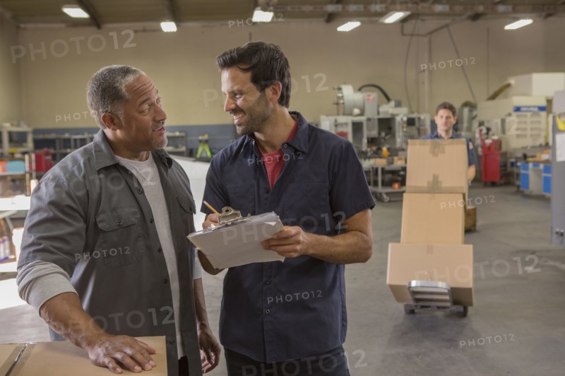 Workers talking in warehouse