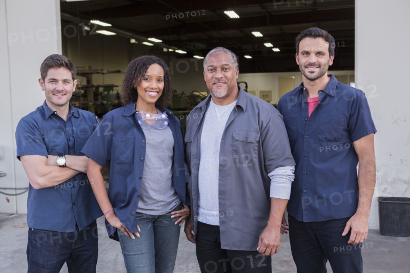 Workers smiling outside warehouse