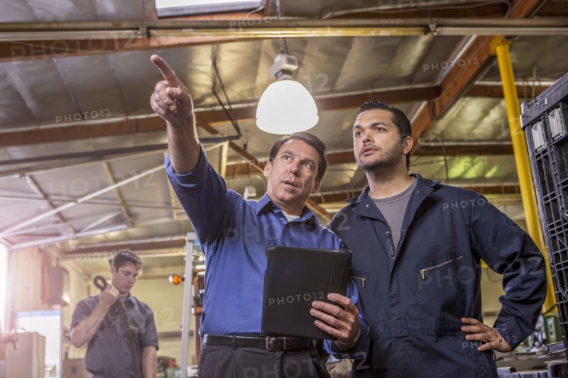Worker and manager talking in warehouse