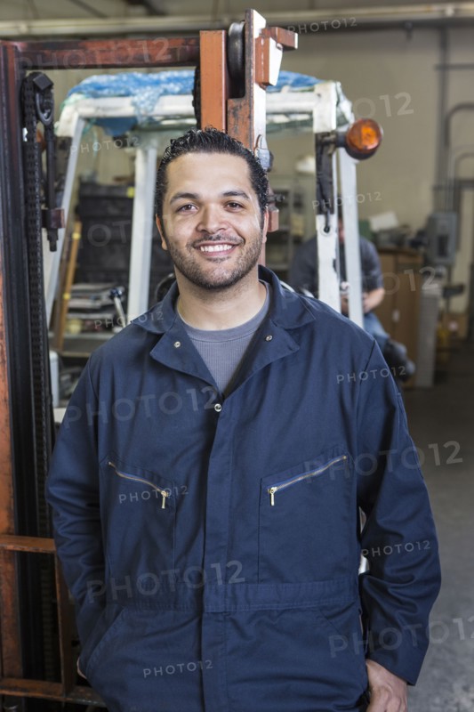 Hispanic worker smiling in warehouse