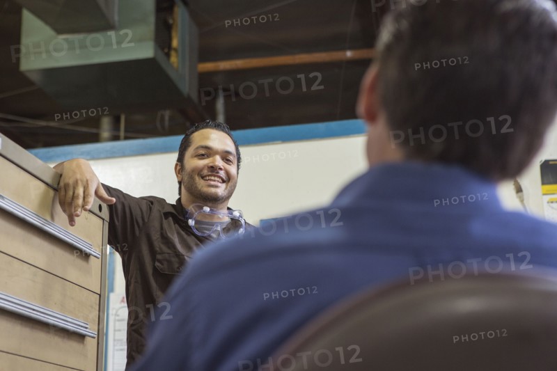 Worker and manager talking in warehouse
