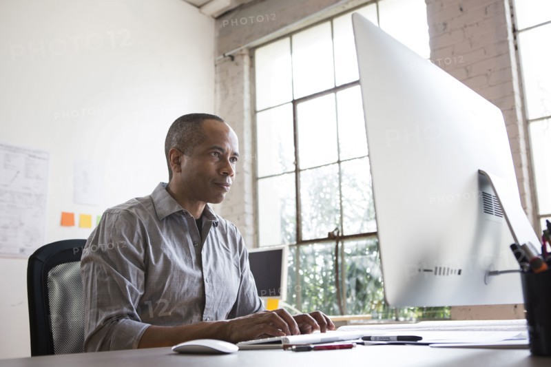 African American architect working in office