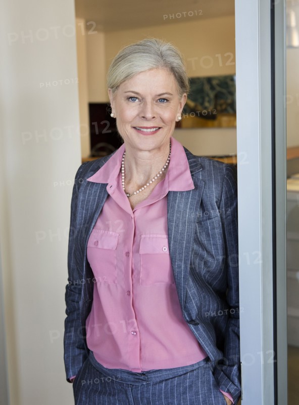 Caucasian businesswoman smiling in office
