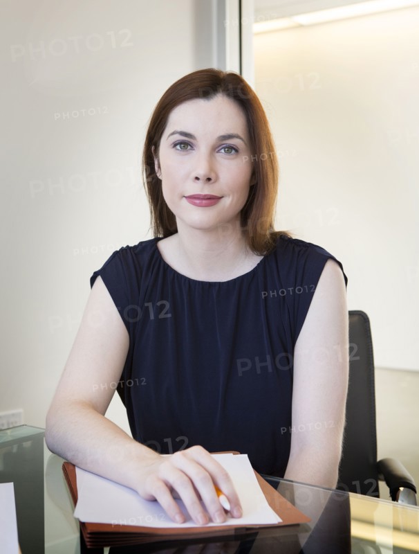 Caucasian businesswoman sitting at desk in office