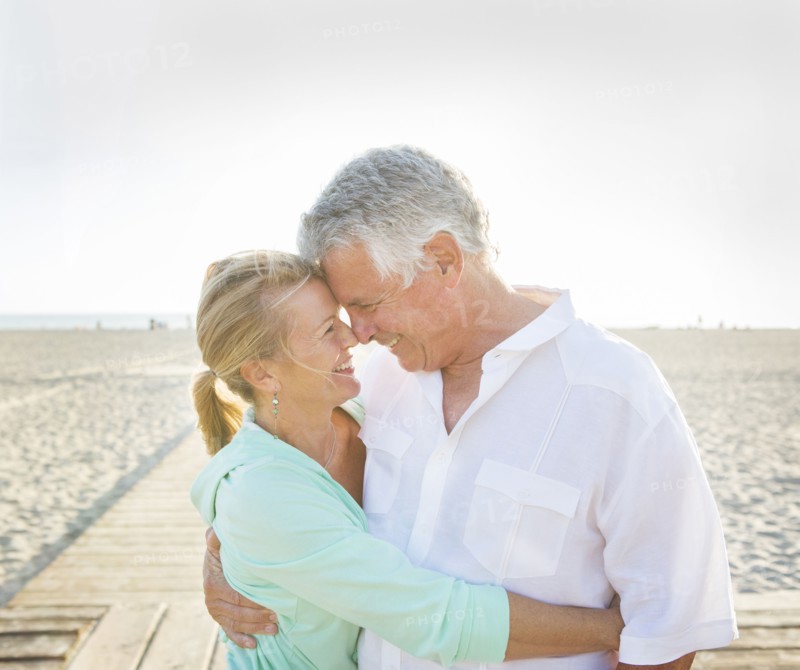 Caucasian couple hugging on beach