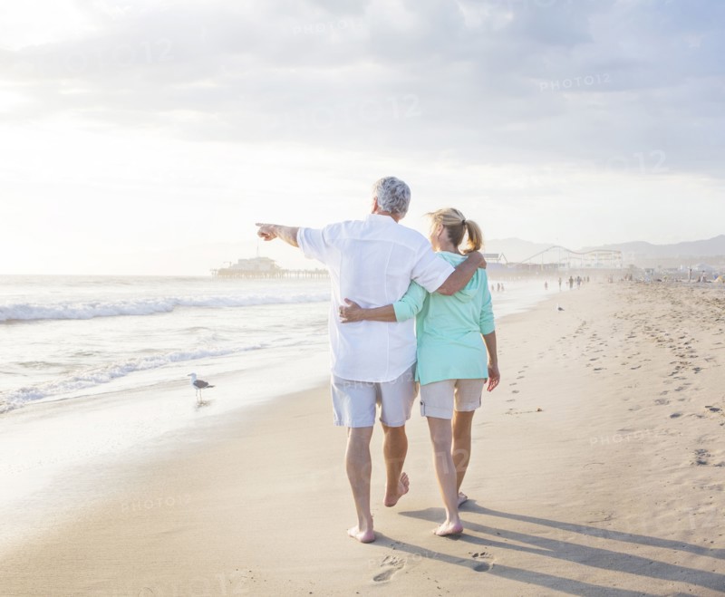 Caucasian couple walking on beach