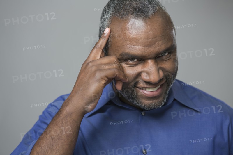 Older African American man tapping his forehead