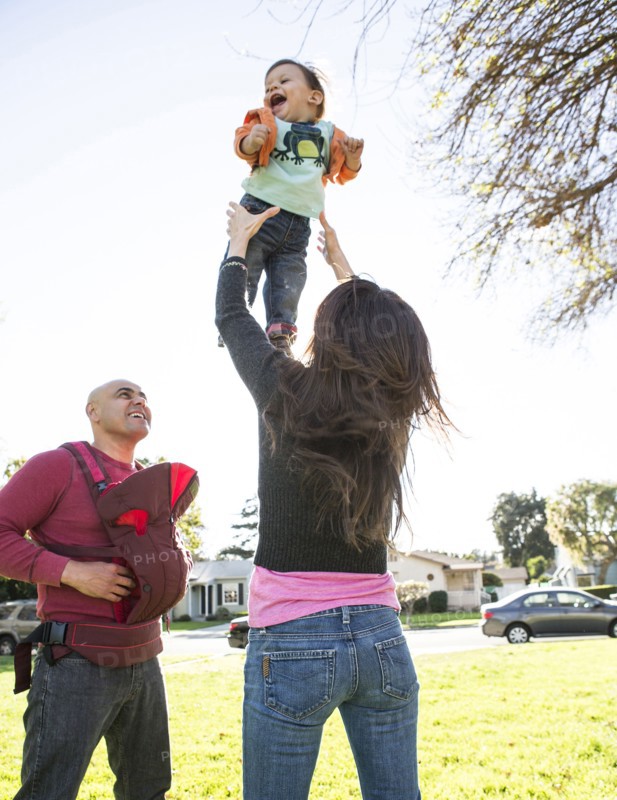 Low angle view of Hispanic family playing in park