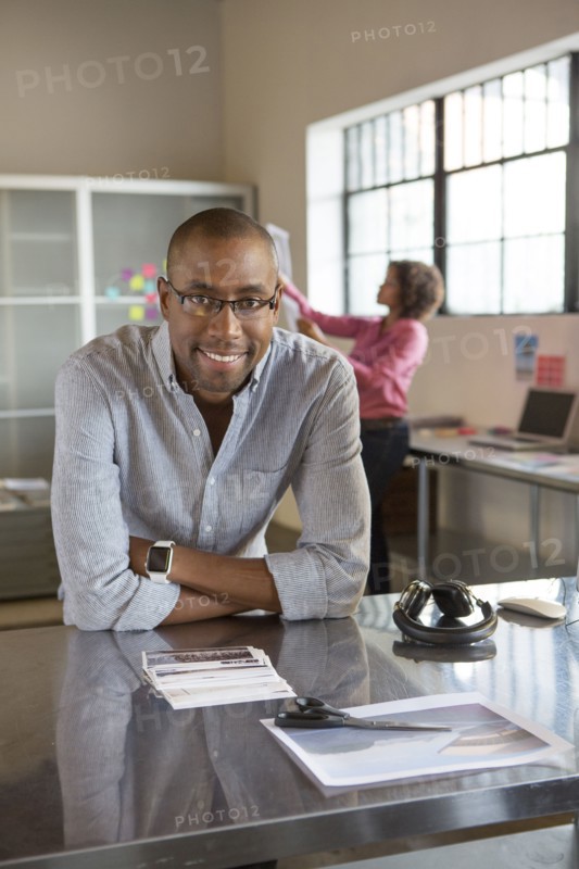 Businessman smiling at desk in office