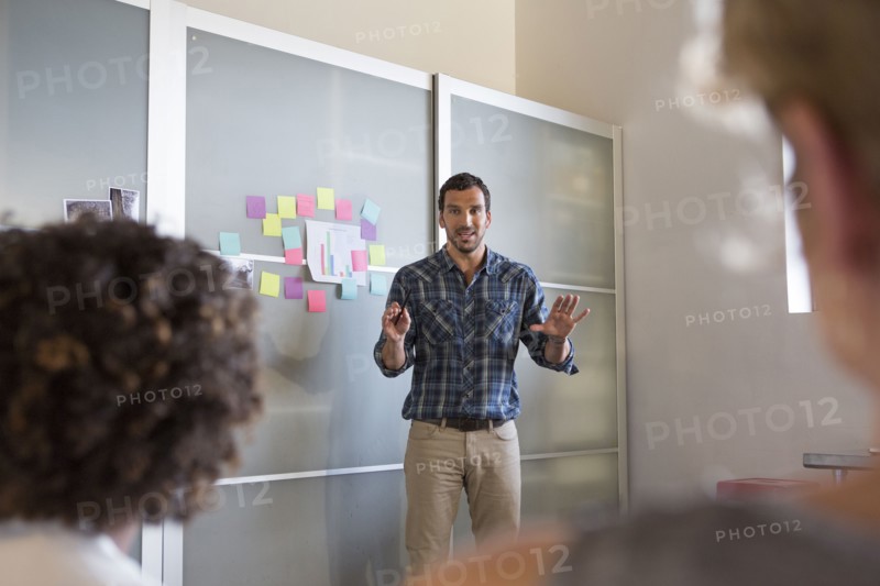Businessman talking to colleagues in office meeting