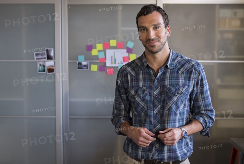 Caucasian businessman smiling in office