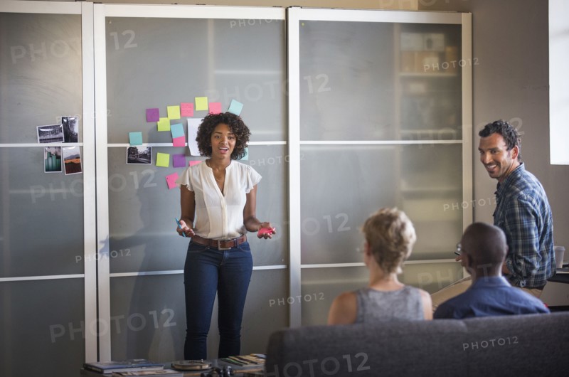 Businesswoman talking to colleagues in office meeting