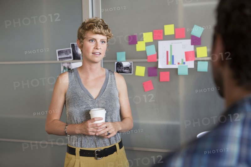 Businesswoman talking to colleague in office