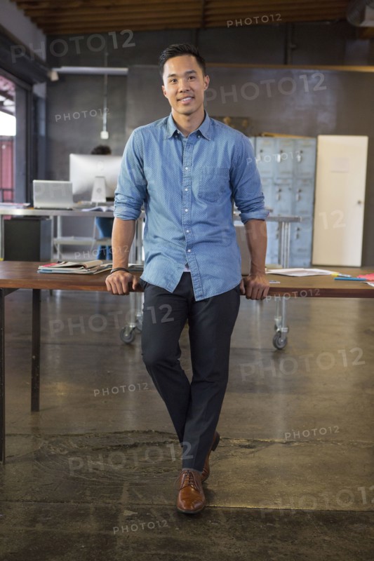Mixed race businessman smiling in office