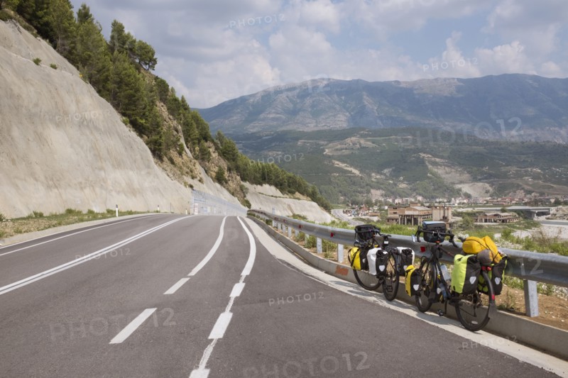 Bicycles leaning on freeway guardrail