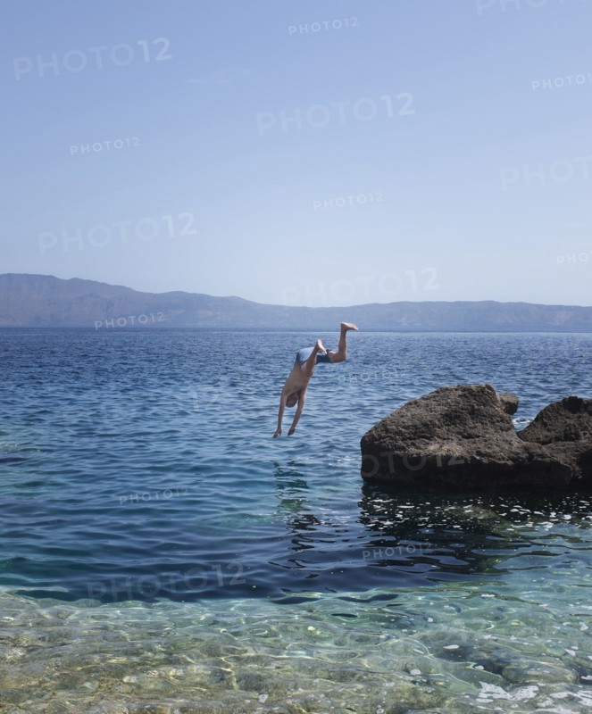 Caucasian man diving into ocean