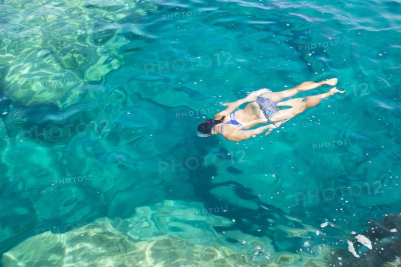 Hispanic woman swimming in ocean