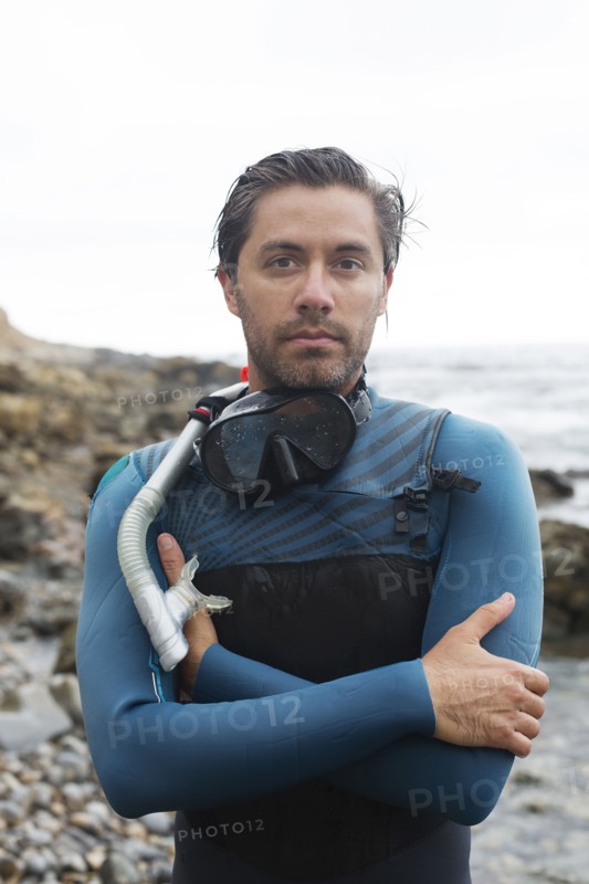 Hispanic diver wearing snorkel mask
