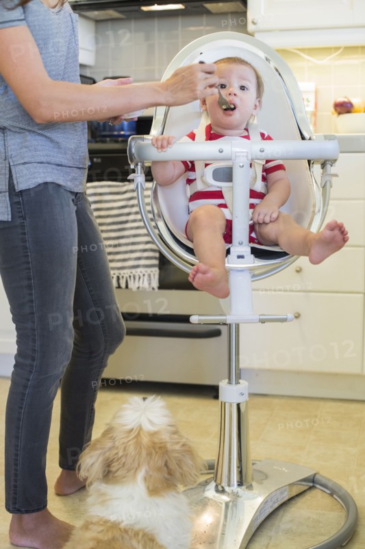 Mixed race mother feeding baby outdoors