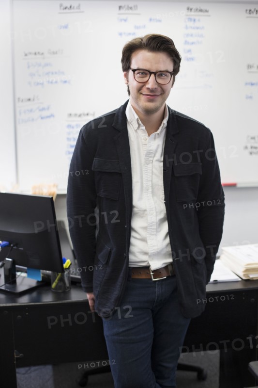 Caucasian businessman smiling in office