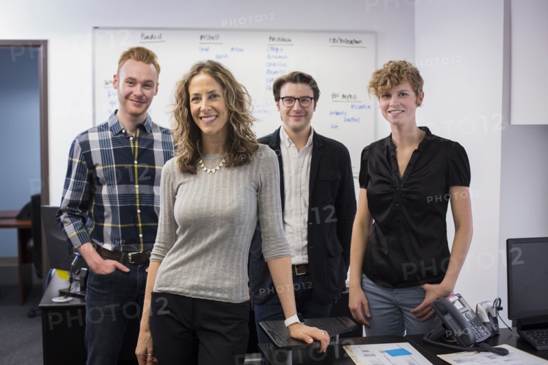 Caucasian business people smiling in office