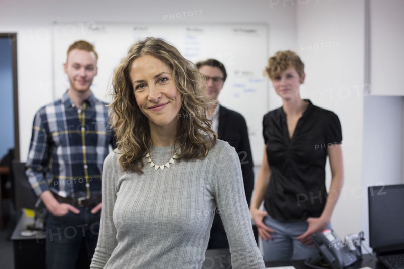 Caucasian businesswoman smiling in office