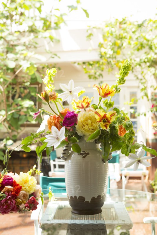 Bouquet of flowers in vase on backyard patio