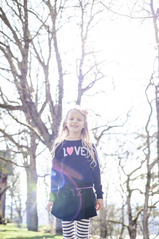 Smiling girl walking in park