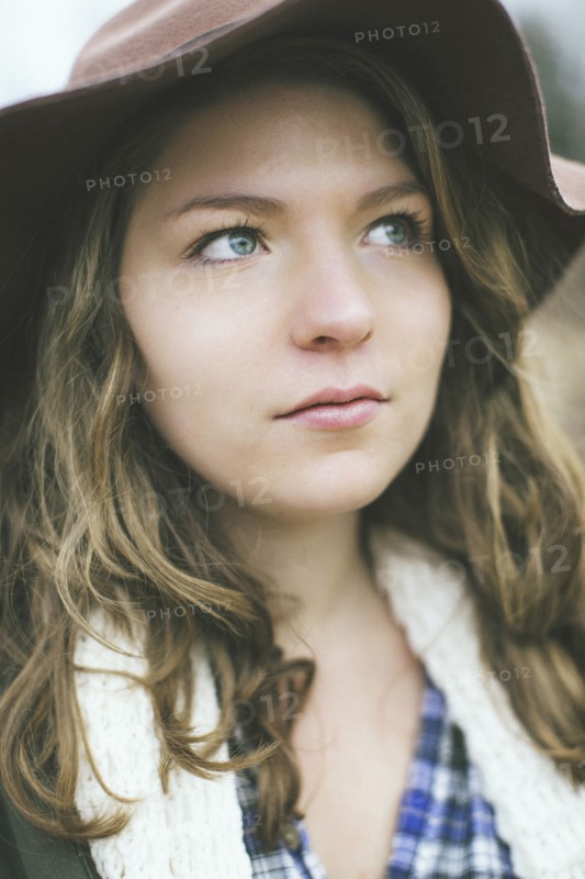 Pensive Caucasian woman wearing sun hat