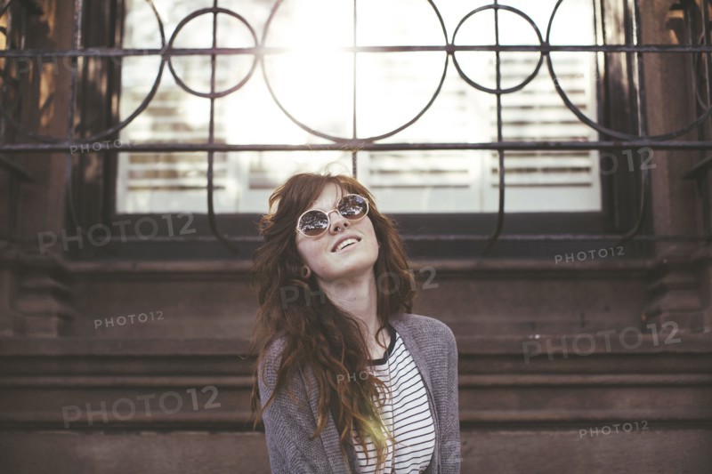Caucasian woman standing under window
