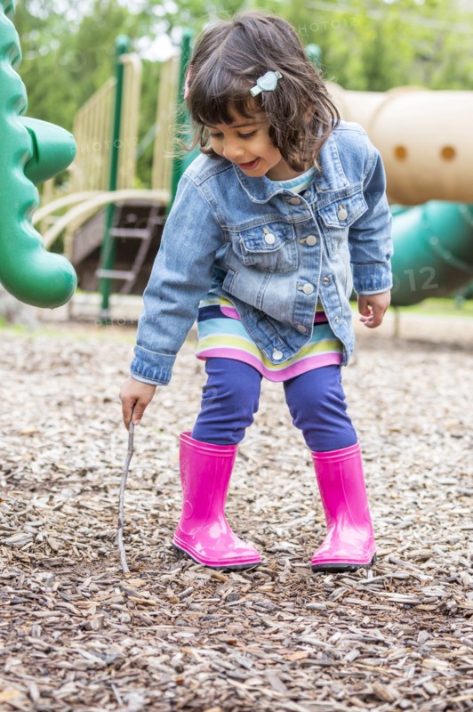 Girl playing with stick at playground