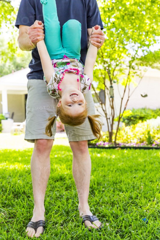 Caucasian father and daughter playing in backyard