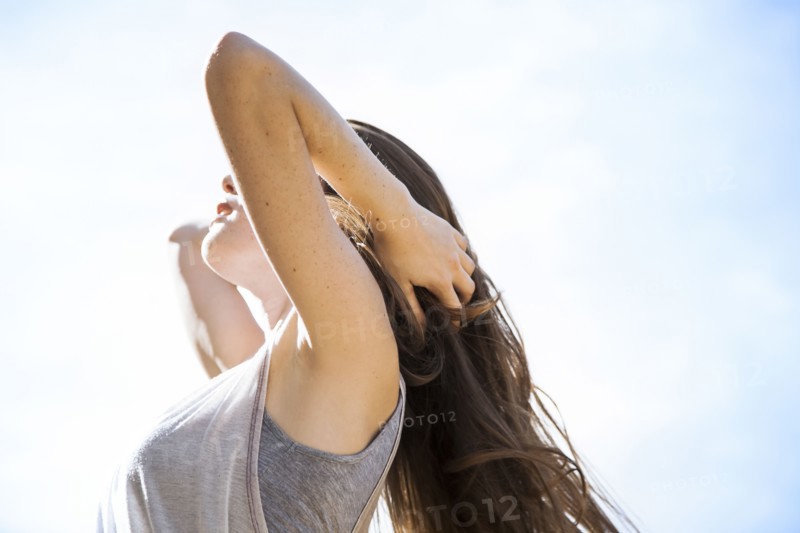 Caucasian woman standing under blue sky