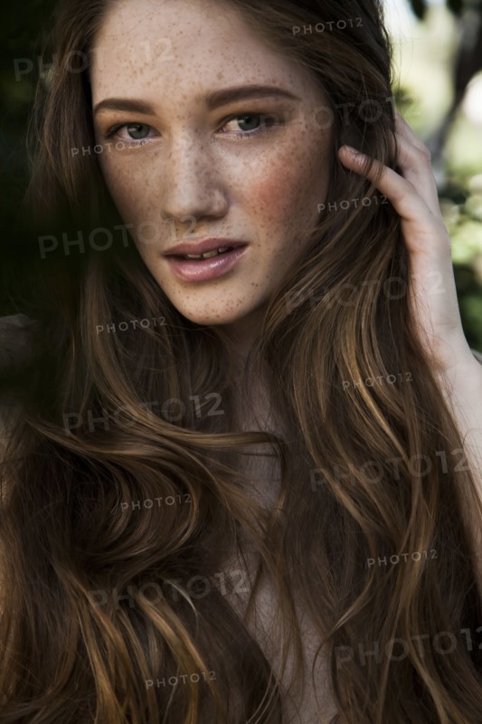 Caucasian woman with long hair and freckles