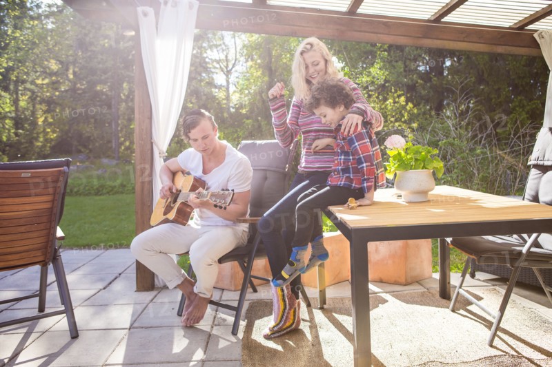 Family relaxing on backyard patio