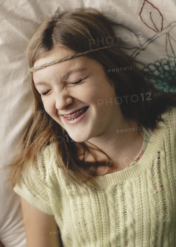 Caucasian girl with braces wearing braid headband