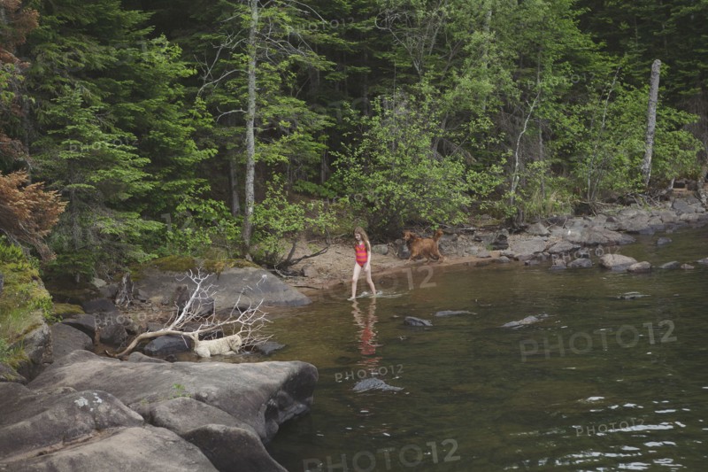 Caucasian girl walking in remote river