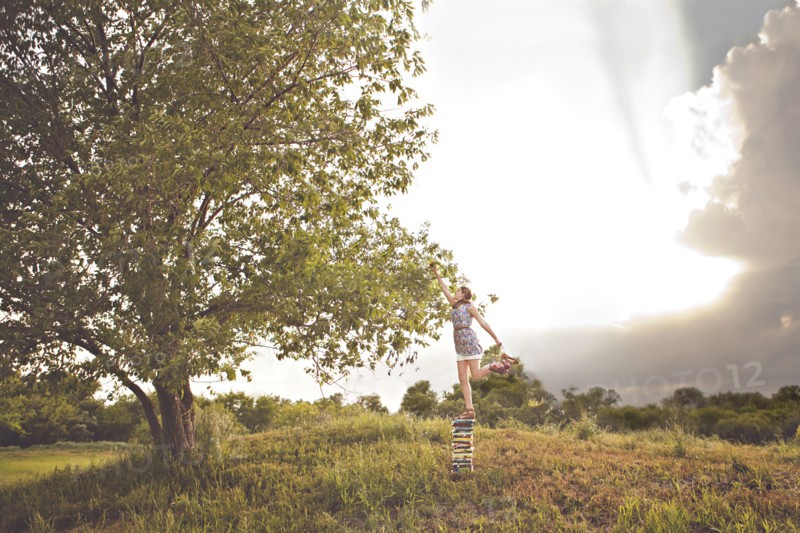 Caucasian girl picking fruit in orchard