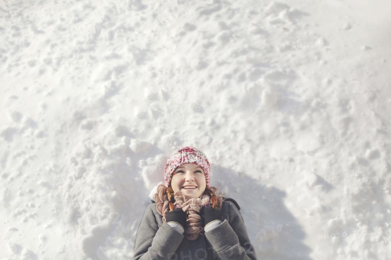 Caucasian girl laying in snow