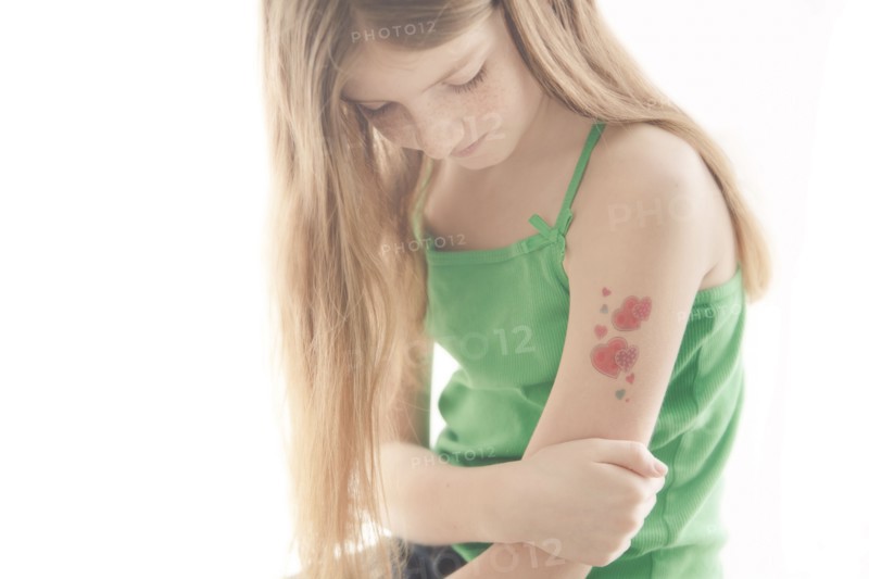 Caucasian girl with temporary tattoo on arm