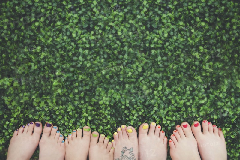 Close up of painted toenails or girls in grass