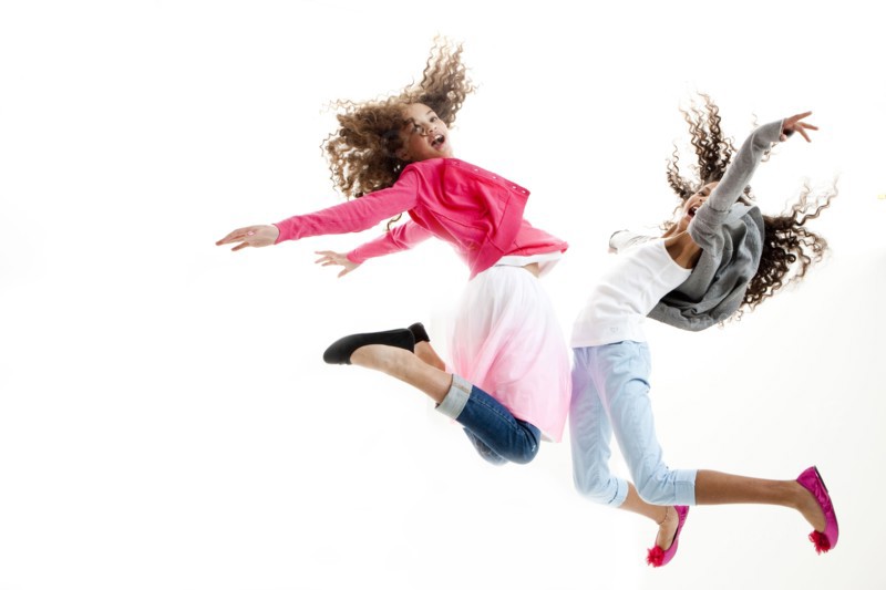 Mixed race girls jumping for joy