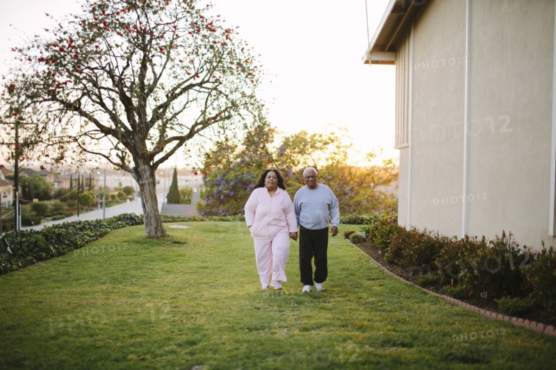 Couple walking in backyard of apartment building