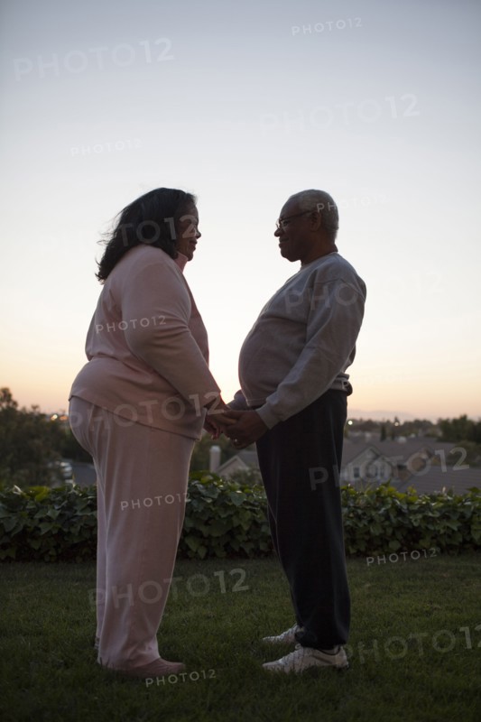 Couple holding hands in backyard